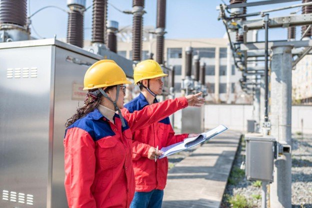 Engineers reviewing electrical system equipment onsite